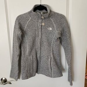 Never worn North Face zip up sweater.